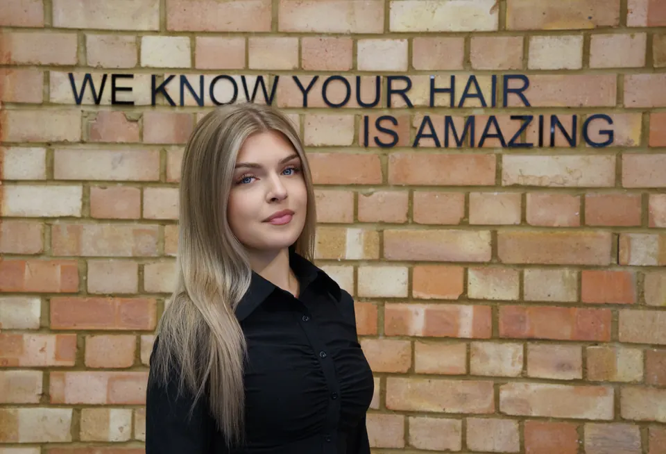 Long blonde hair against the brick wall