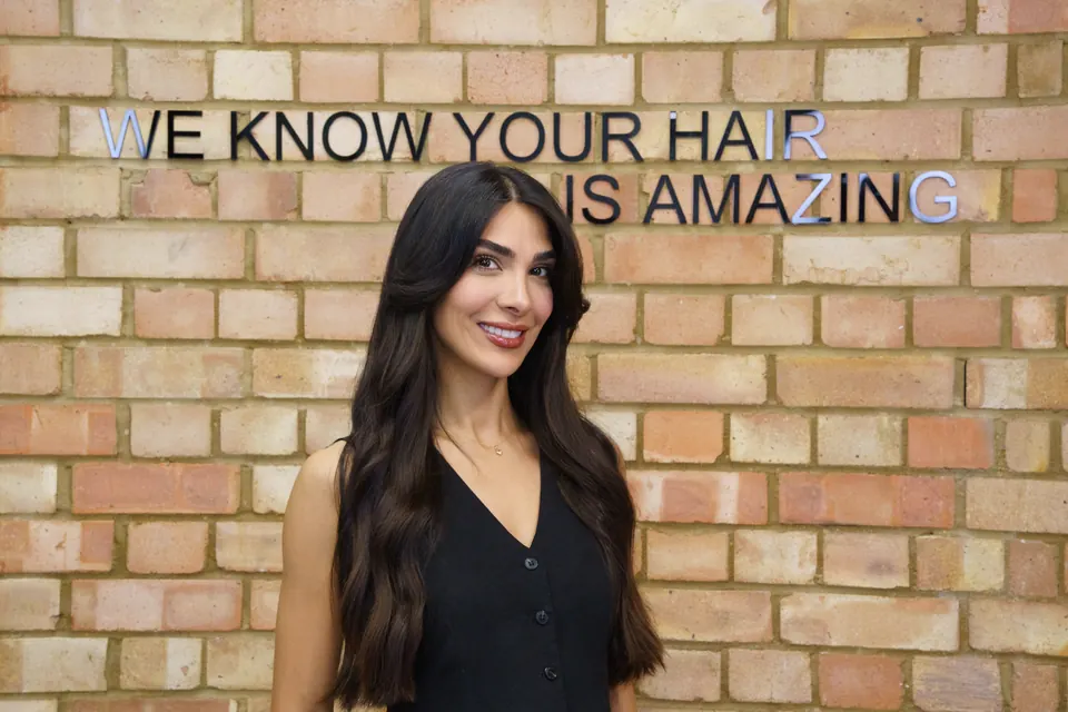 Fatima in front of the brick wall