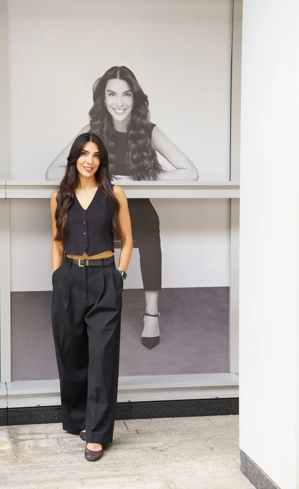 Fatima in front of her portrait in the salon window