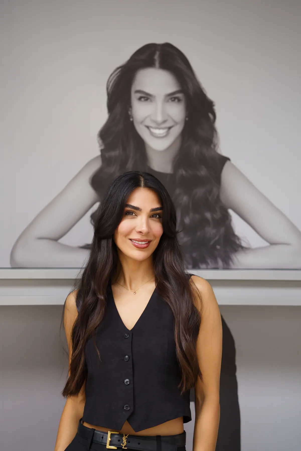 Fatima in front of her portrait in the salon window